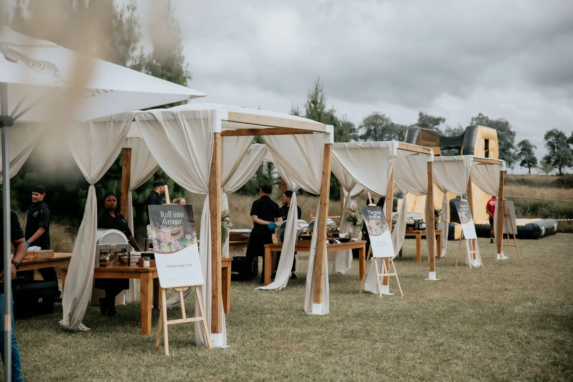 White wedding cabanas across an open field in KZN